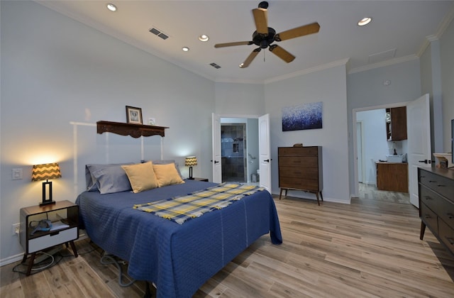 bedroom with crown molding, ceiling fan, ensuite bath, and light hardwood / wood-style flooring