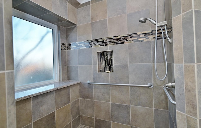 bathroom with tiled shower