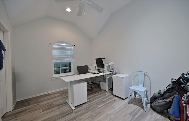 home office with vaulted ceiling, light hardwood / wood-style floors, and ceiling fan