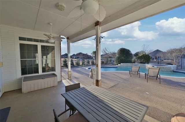 view of patio with a fenced in pool and ceiling fan