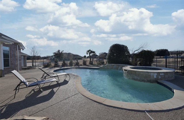 view of swimming pool with a patio area and an in ground hot tub