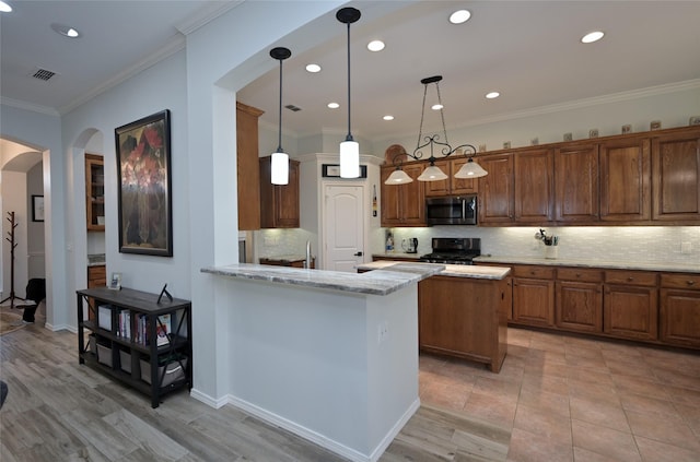 kitchen with decorative light fixtures, tasteful backsplash, stove, light stone counters, and kitchen peninsula