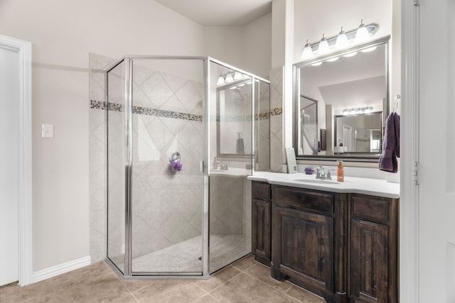 bathroom featuring vanity, an enclosed shower, and tile patterned floors