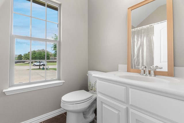 bathroom featuring vanity, tile patterned flooring, and toilet