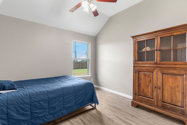 bedroom featuring lofted ceiling, light hardwood / wood-style flooring, and ceiling fan