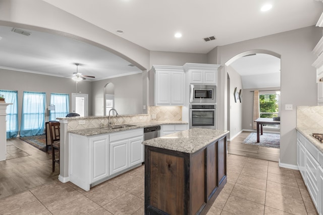 kitchen with white cabinetry, sink, kitchen peninsula, and appliances with stainless steel finishes