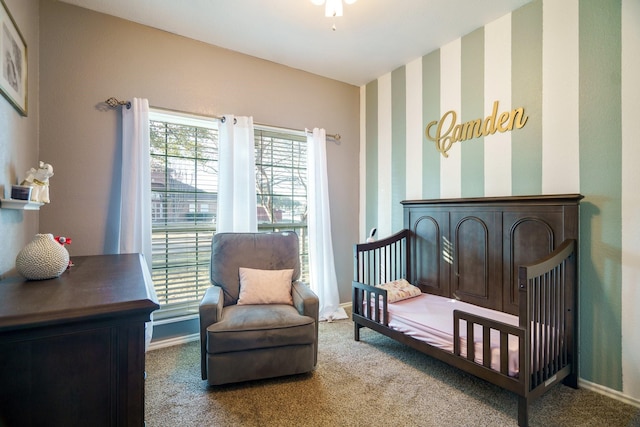 bedroom with a crib and carpet