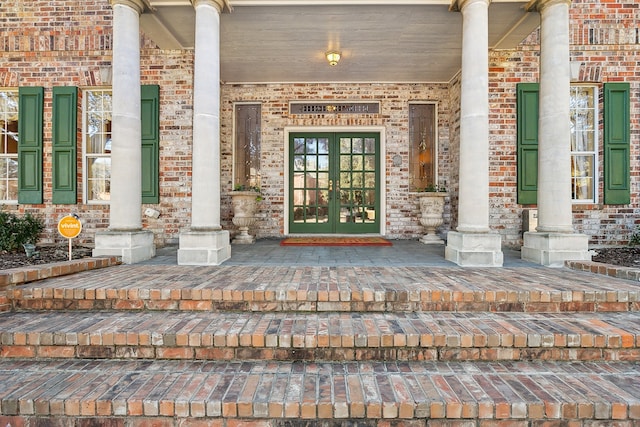 view of exterior entry with french doors and covered porch