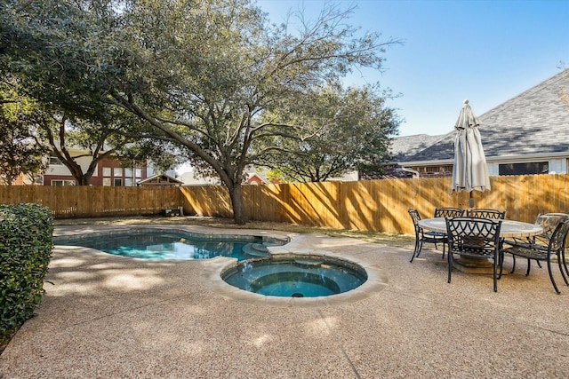 view of pool with an in ground hot tub and a patio