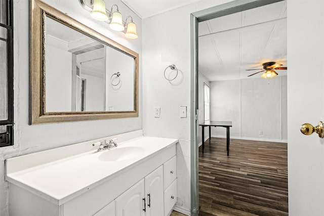 bathroom with hardwood / wood-style flooring, ceiling fan, and vanity