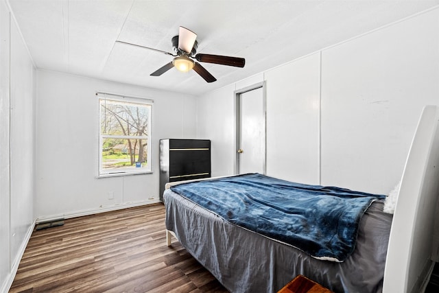 bedroom with wood-type flooring and ceiling fan