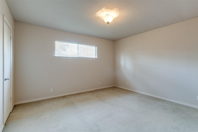 spare room featuring light colored carpet