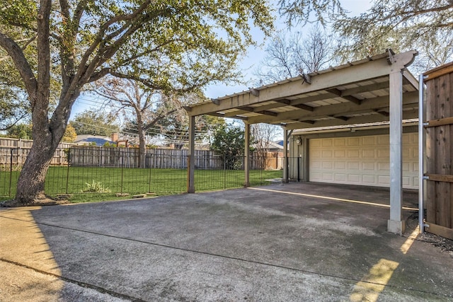 view of patio / terrace with a carport and a garage