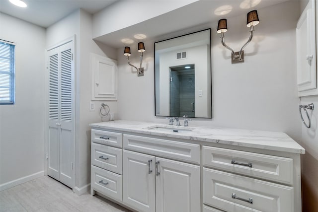 bathroom featuring vanity and an enclosed shower