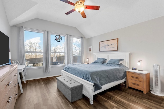 bedroom with vaulted ceiling, dark hardwood / wood-style floors, and ceiling fan