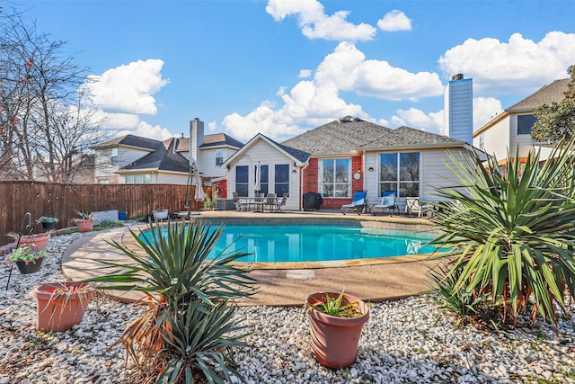 view of swimming pool with area for grilling and a patio area