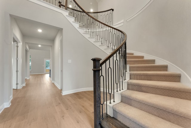 304 Alicia Ct, Mansfield, TX 76063 - stairway featuring a towering ceiling, baseboards, and wood finished floors