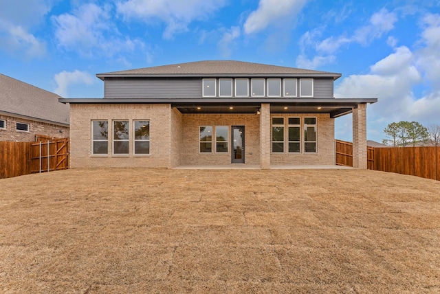 304 Alicia Ct, Mansfield, TX 76063 - back of house featuring a patio area, a fenced backyard, a lawn, and brick siding