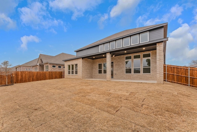 304 Alicia Ct, Mansfield, TX 76063 - rear view of property featuring a patio, brick siding, and a fenced backyard