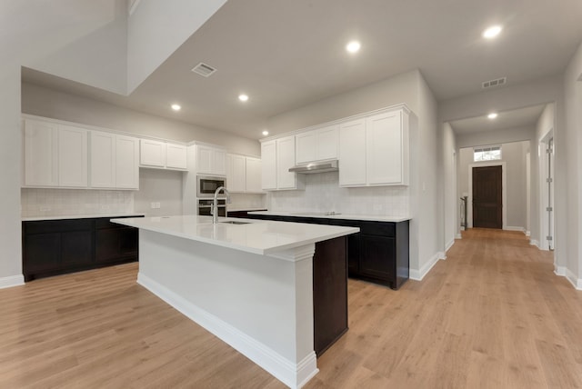 304 Alicia Ct, Mansfield, TX 76063 - kitchen with visible vents, light countertops, a kitchen island with sink, and white cabinets
