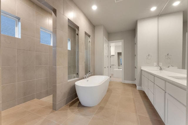 304 Alicia Ct, Mansfield, TX 76063 - full bathroom featuring double vanity, a soaking tub, a sink, a walk in shower, and tile patterned floors