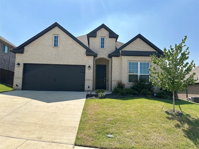 view of front of house featuring a garage and a front yard