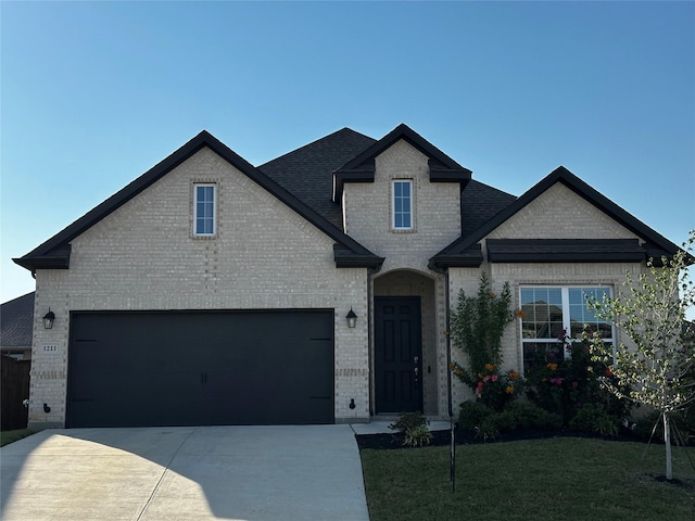 view of front facade with a garage and a front lawn