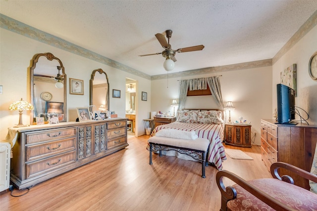 bedroom with ceiling fan, a textured ceiling, and light hardwood / wood-style floors