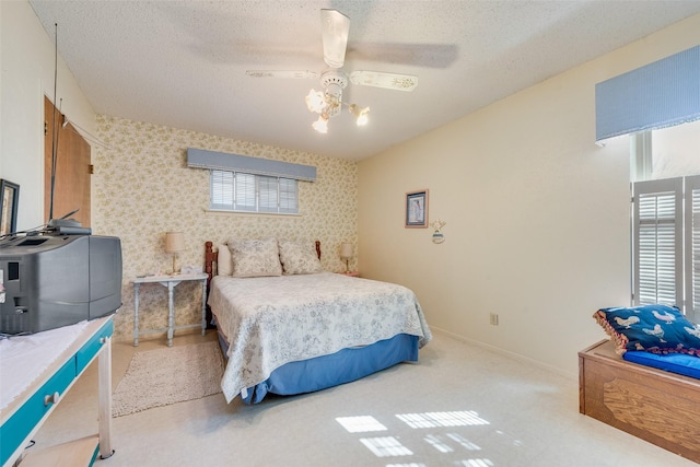 carpeted bedroom with a textured ceiling and ceiling fan