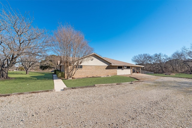 view of property exterior featuring a carport and a yard