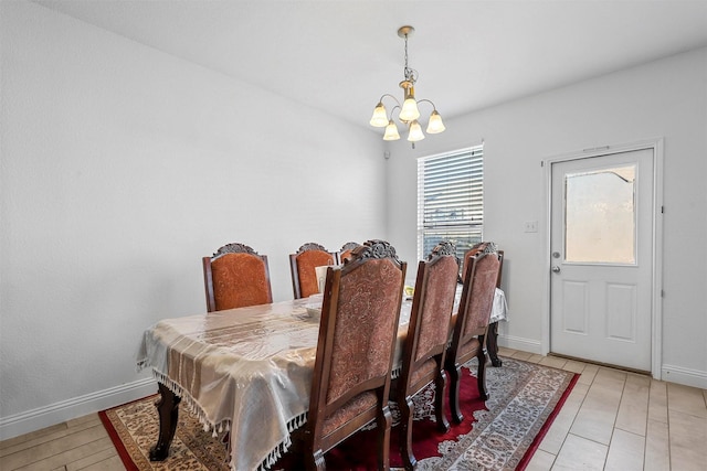 tiled dining area featuring a notable chandelier