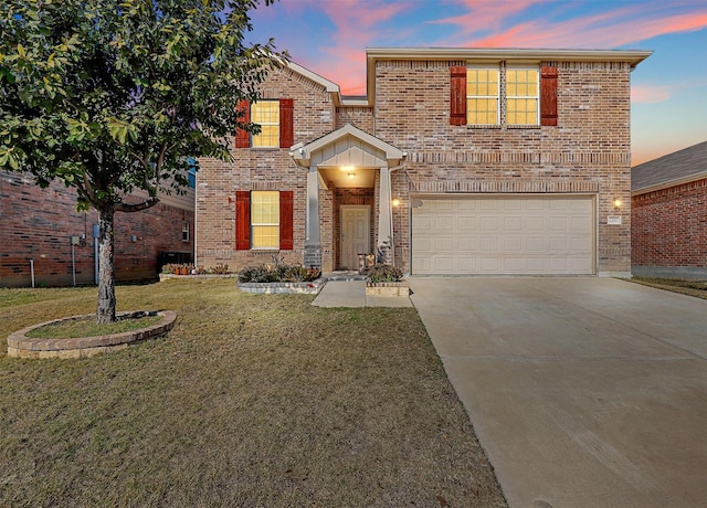 front of property with a garage and a lawn