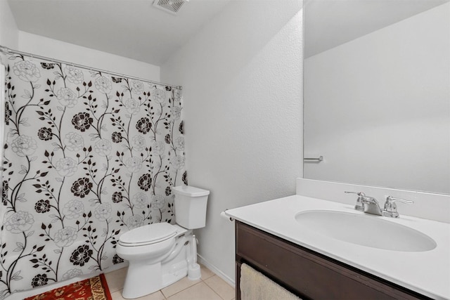 bathroom with vanity, toilet, and tile patterned flooring