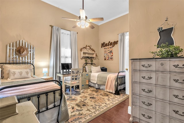 bedroom featuring crown molding, lofted ceiling, ceiling fan, and dark hardwood / wood-style flooring