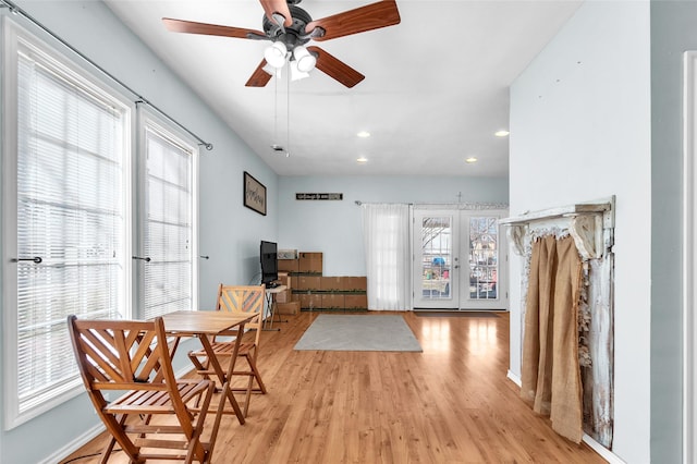 sitting room with ceiling fan and light hardwood / wood-style flooring