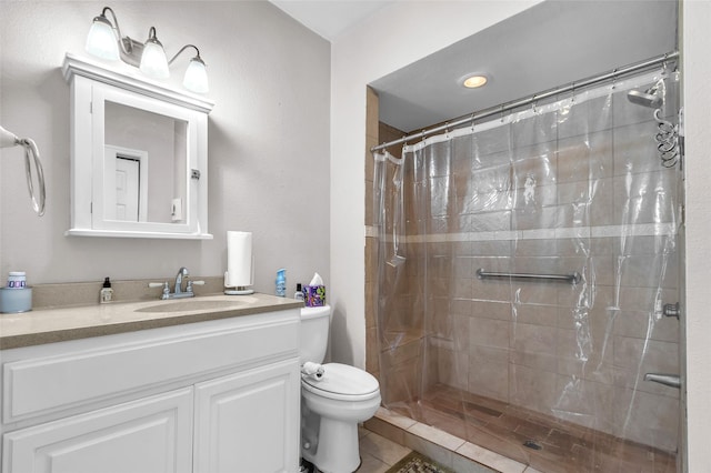 bathroom featuring tile patterned flooring, vanity, curtained shower, and toilet