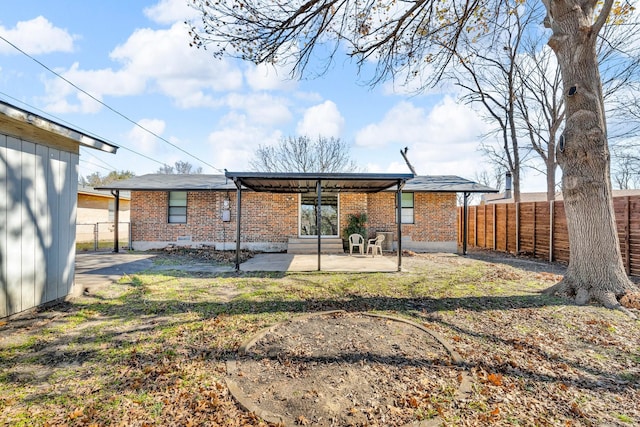 back of property featuring a patio and a lawn