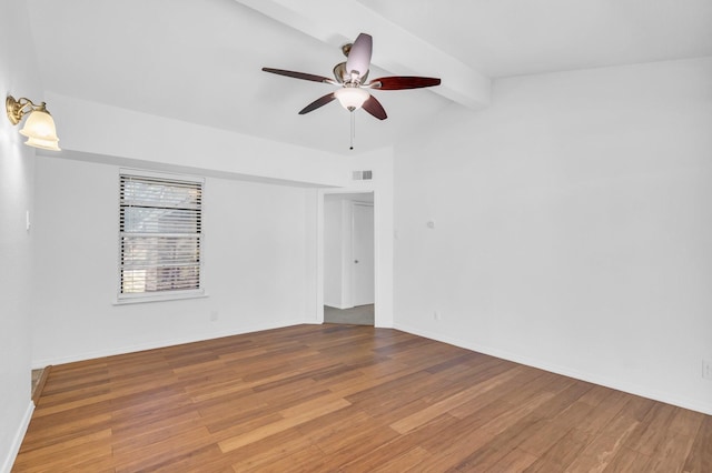 empty room with hardwood / wood-style flooring, lofted ceiling with beams, and ceiling fan