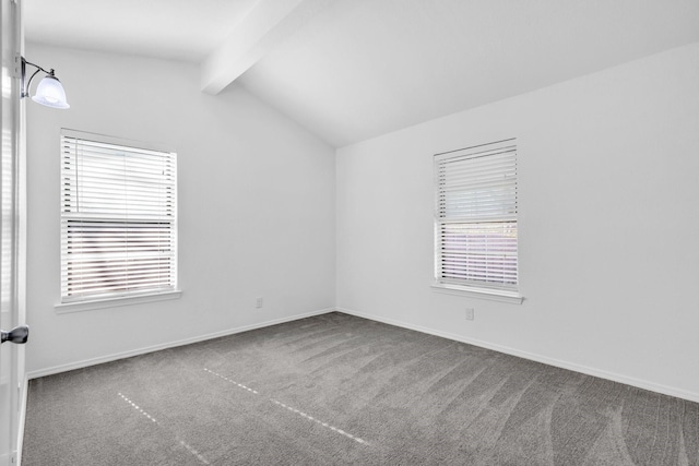 spare room featuring carpet floors and vaulted ceiling with beams