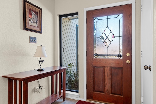 tiled entryway featuring a healthy amount of sunlight