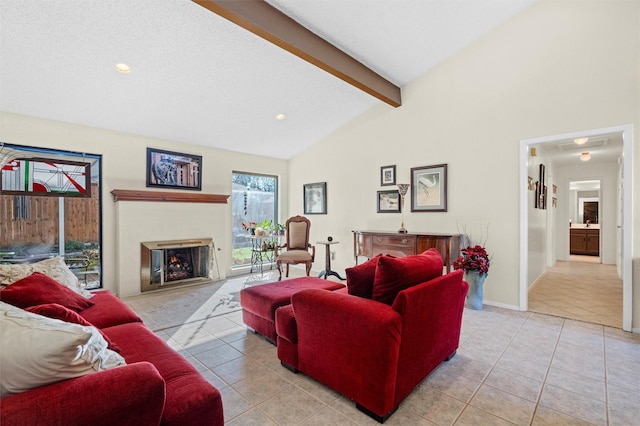 living room featuring lofted ceiling with beams, light tile patterned flooring, and a textured ceiling