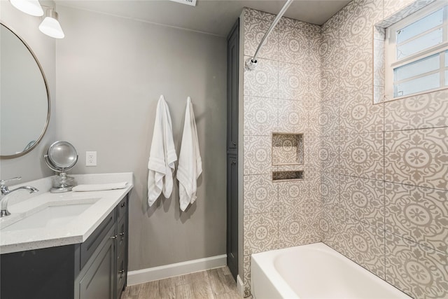 bathroom featuring vanity, wood-type flooring, and washtub / shower combination