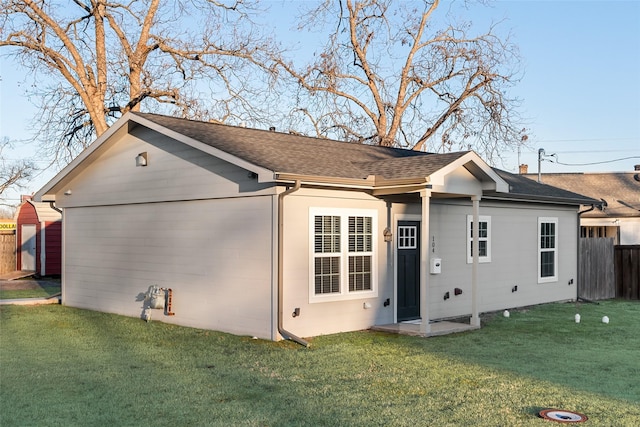 back of house with a lawn