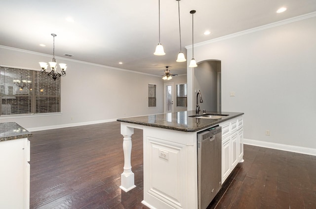 kitchen featuring dishwasher, white cabinetry, a center island with sink, and a sink