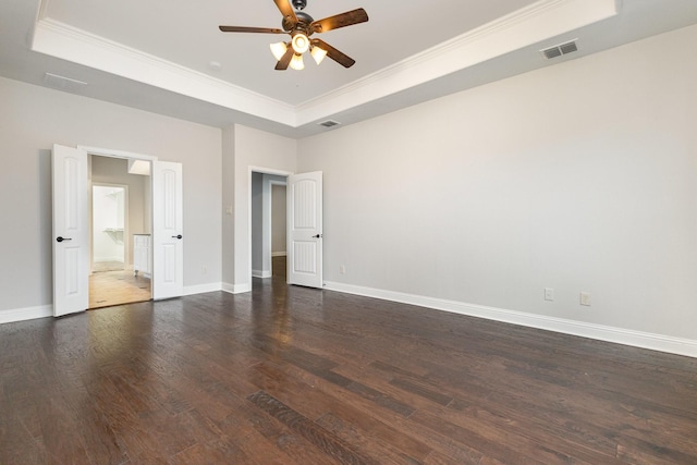 unfurnished bedroom featuring ceiling fan, dark hardwood / wood-style floors, and a raised ceiling