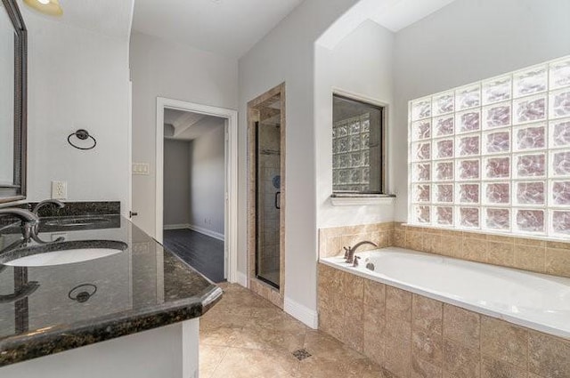 bathroom with sink, tile patterned floors, and separate shower and tub