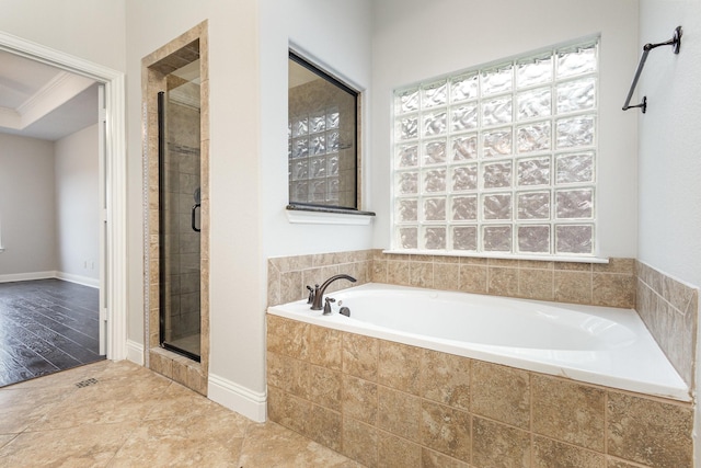 full bath with crown molding, a shower stall, baseboards, and a bath