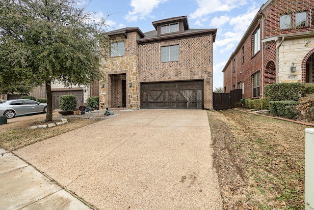 view of front facade featuring a garage, driveway, brick siding, and stone siding