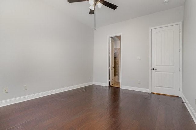 empty room featuring ceiling fan and dark hardwood / wood-style flooring