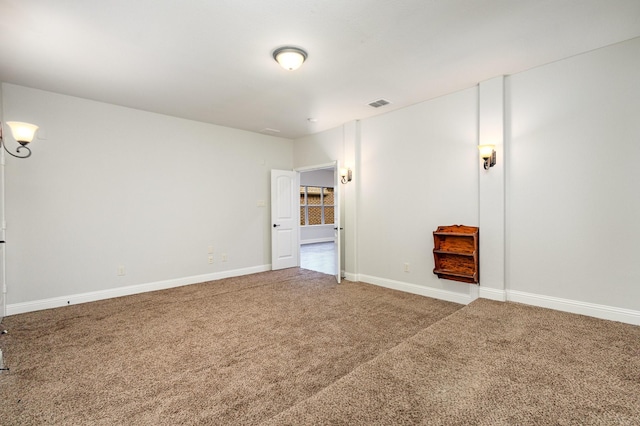 unfurnished room with carpet floors, baseboards, and visible vents